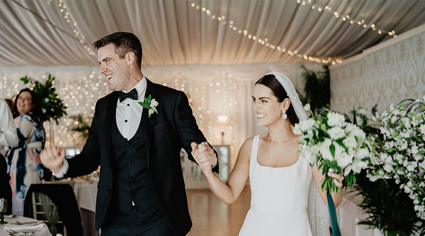 joyful couple celebrating their wedding day, highlighting expert wedding photography in Ashley Park house