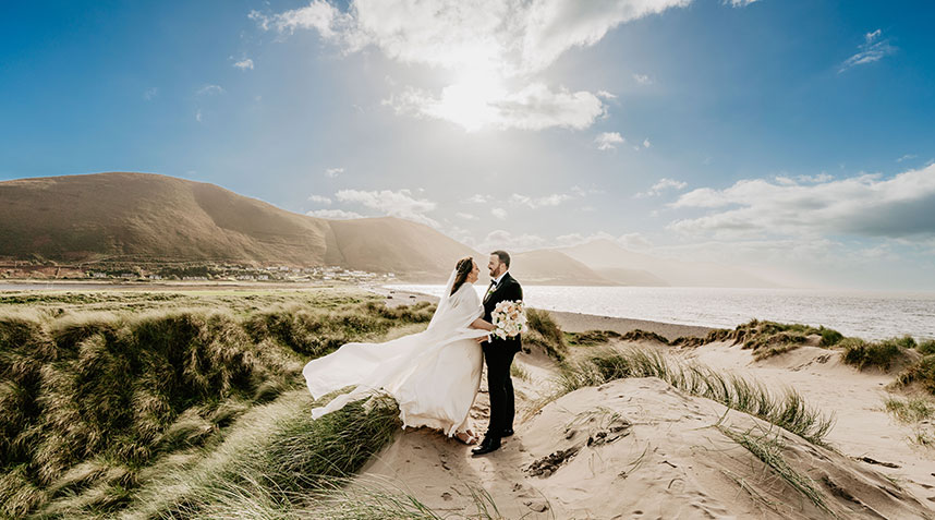 The first kiss as a married couple, captured in award-winning wedding photography style.